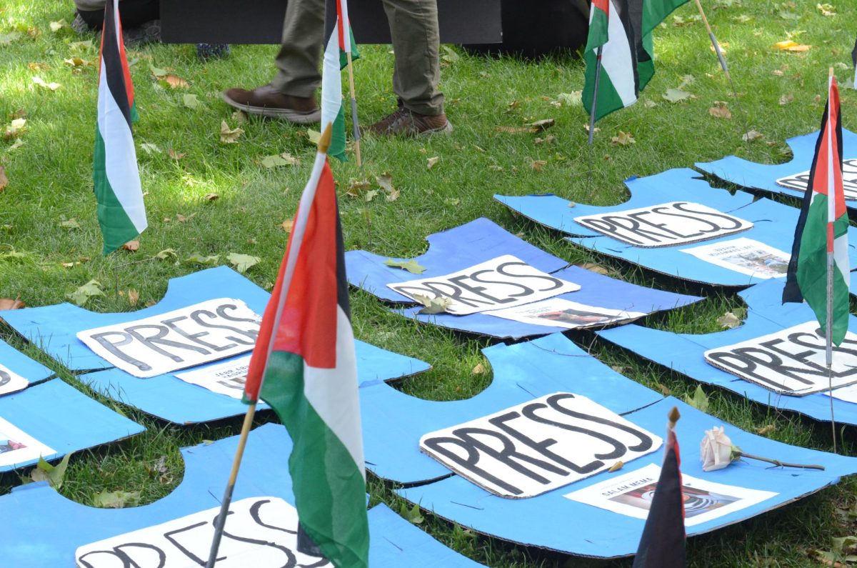 Photos of journalists who lost their lives in the Palestine Israel conflict form a large circle on Kendall Halls lawn.
