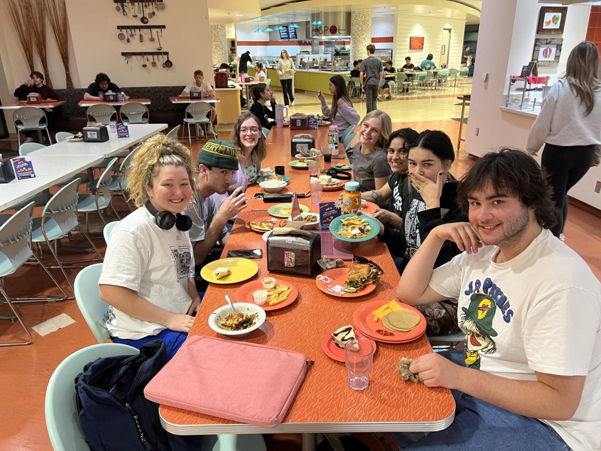 Left side of table, Jenna McMahon, Nathan Chiochios and Jessica Miller sit with, on the right side front to back, Callum Standish, Molly Myers, Nadia Hill, and Grace Stark at  Estom Jamani Dining Commons. Photo taken April 29 by a kind employee at the dining hall. 