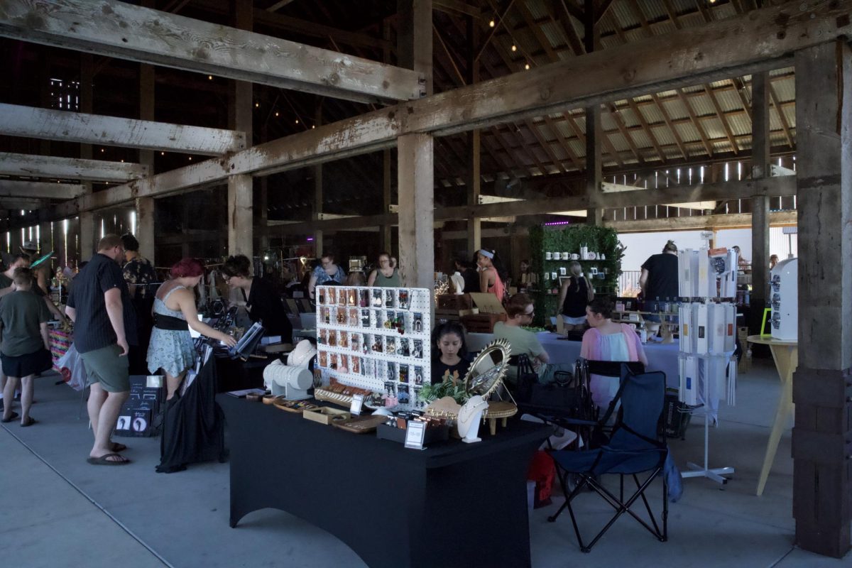 Community gathers in The Barn at Merriam Park to browse local art and businesses. Photo taken by Lexi Lynn on Sept. 22