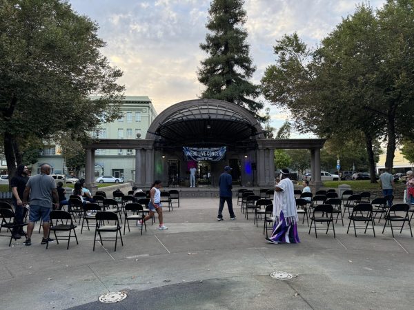 People congregate as members of Victory Chapel work on setting up the stage for Lacy B’s performance. Some onlookers curiously linger, inquiring with audience members about the event. Photo taken by Lexi Lynn on Sept. 14.