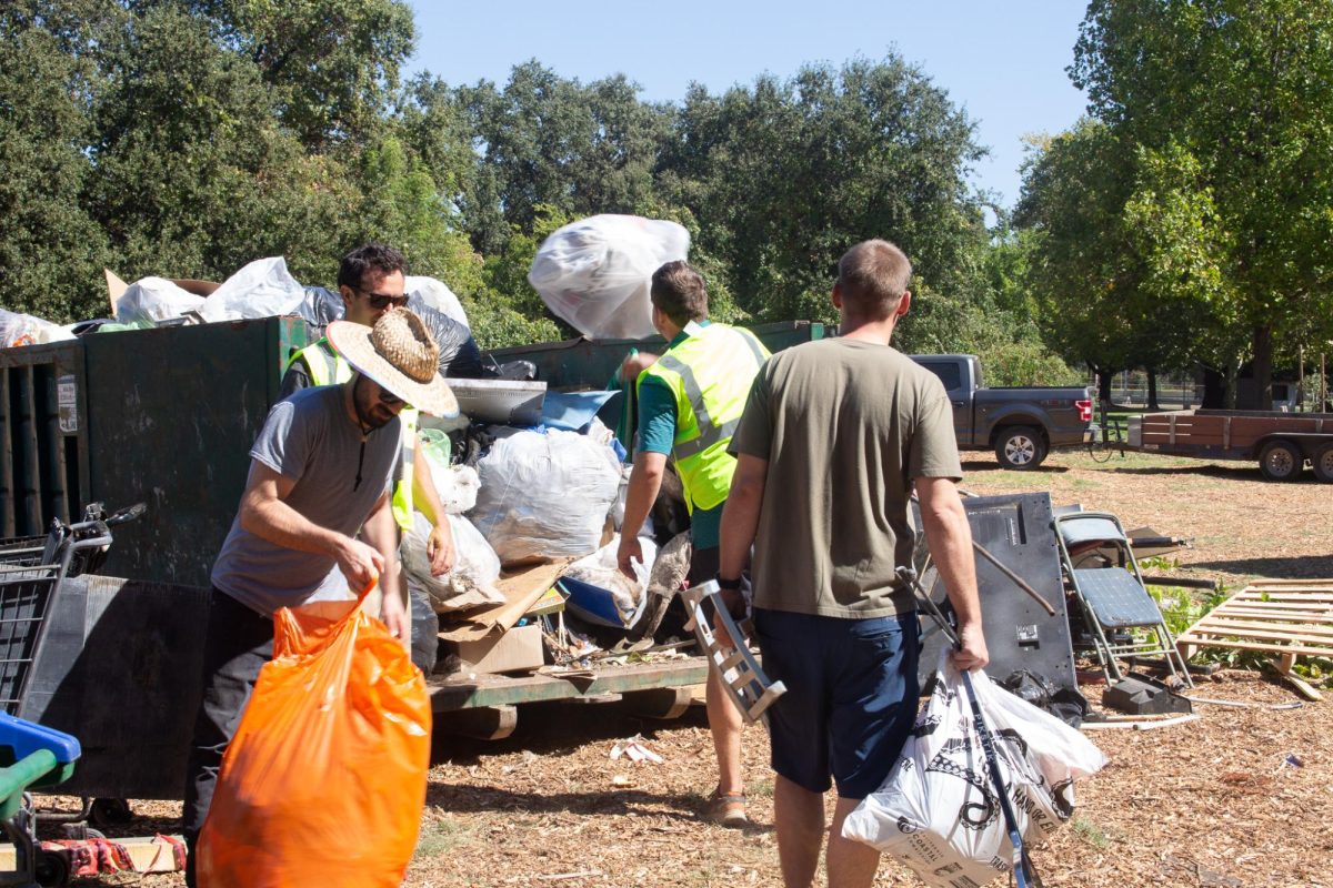 Volunteers throw trash into the correct bins at Hooker Oak Park on Sept. 21. All the trash was picked up from around Bidwell Park and Chico Creeks.