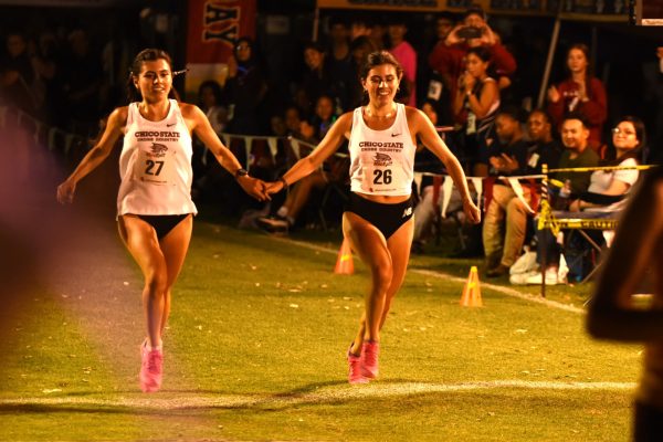 Della and Iresh Molina crossing the finish line at the Kym Duyst Twilight Invitational at Stanislaus State. The twins said that they didn’t plan on holding hands before the race, deciding to do it right at the end of the race. Taken by Scott Durham on Sept. 14.