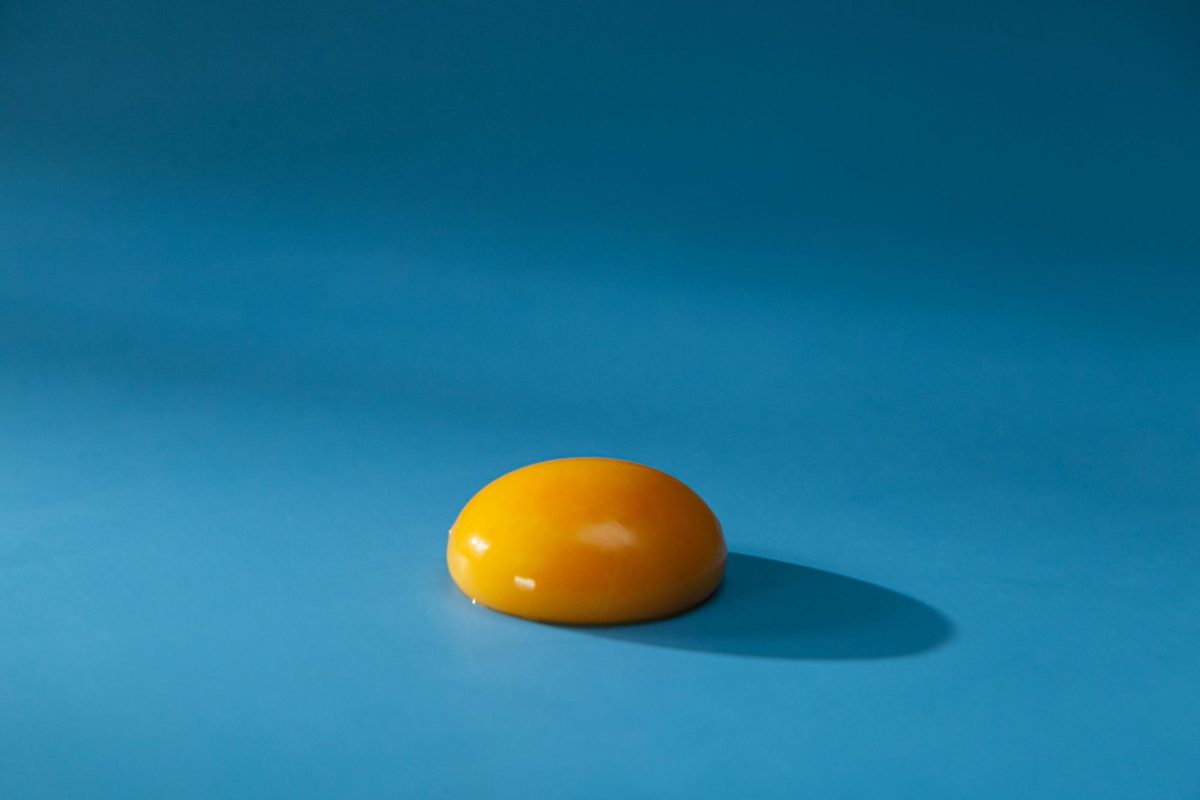 Egg yolk on blue surface. Photo by Ron Lach, from Pexels