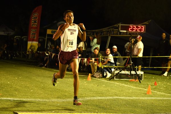 Chico State Men's Cross Country runner Damian Garcia finishing in second at Stanislaus State's Kim Duyst Twilight Invitational. Garcia set his PR in the 8k running a 23:23.4 in his hometown of Turlock. Photo taken by Scott Durham on Sep. 14, 2024