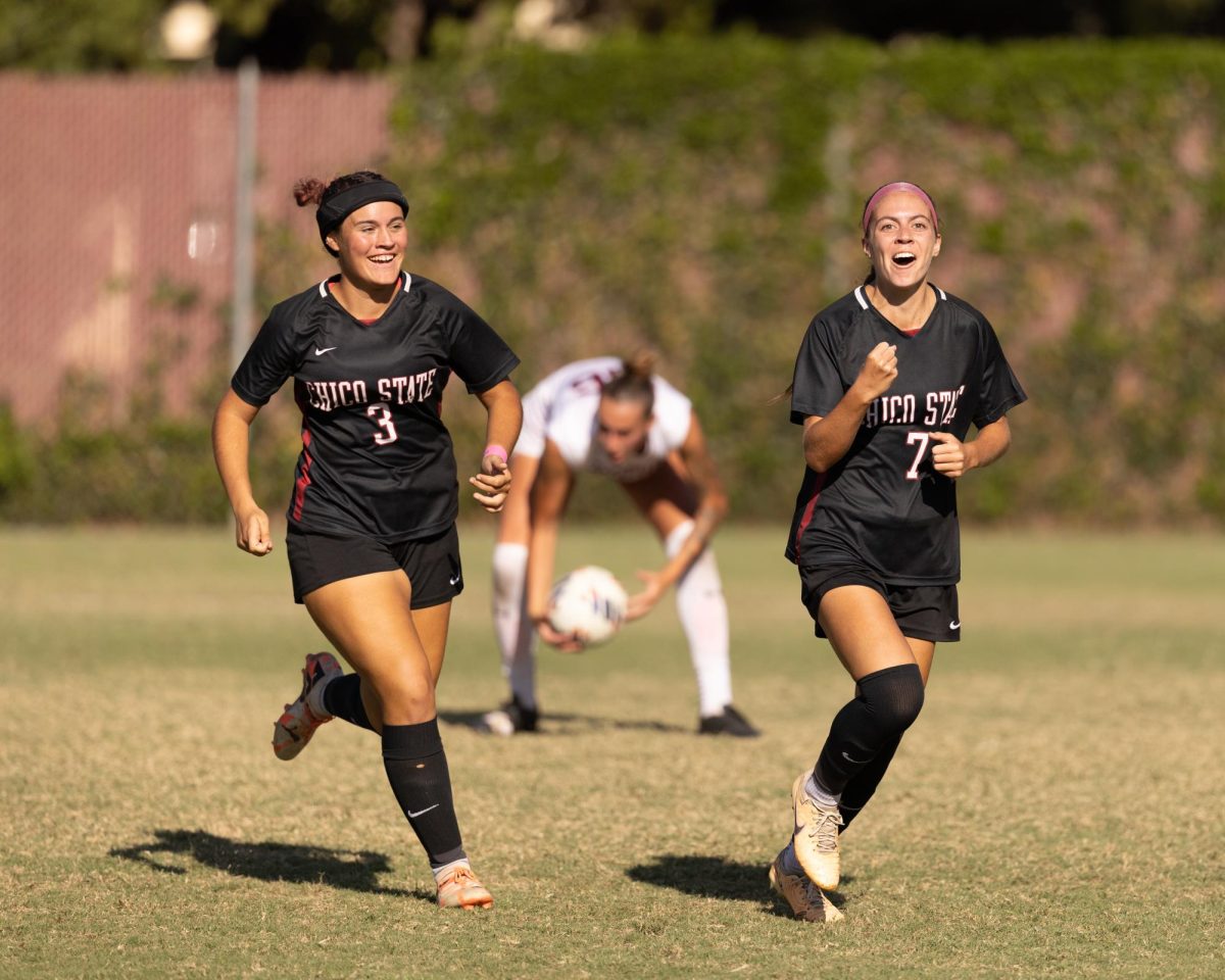 Chico State’s junior midfielder Hannah Pieri and freshman forward Caroline Souza celebrate Pieri’s game-tying goal in the 66th minute of the game against the Cal State Dominguez Hills Toros on Oct. 6. Taken by Aaron Draper.