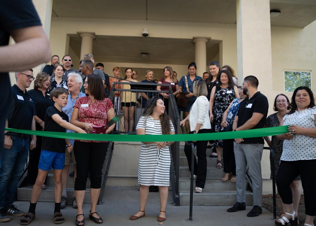 Community member and housing developers join for the ribbon cutting ceremony at Shotover Inn apartments Wednesday Oct. 2, in Hamilton City. Photo taken by Jenna McMahon on Oct. 2.