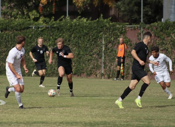 Senior Forward Miles Rice (#5) dribbles the ball down the field into enemy territory during a game against Cal State San Bernardino on Oct. 27 in Chico. Photo taken by Trevor Lee.
