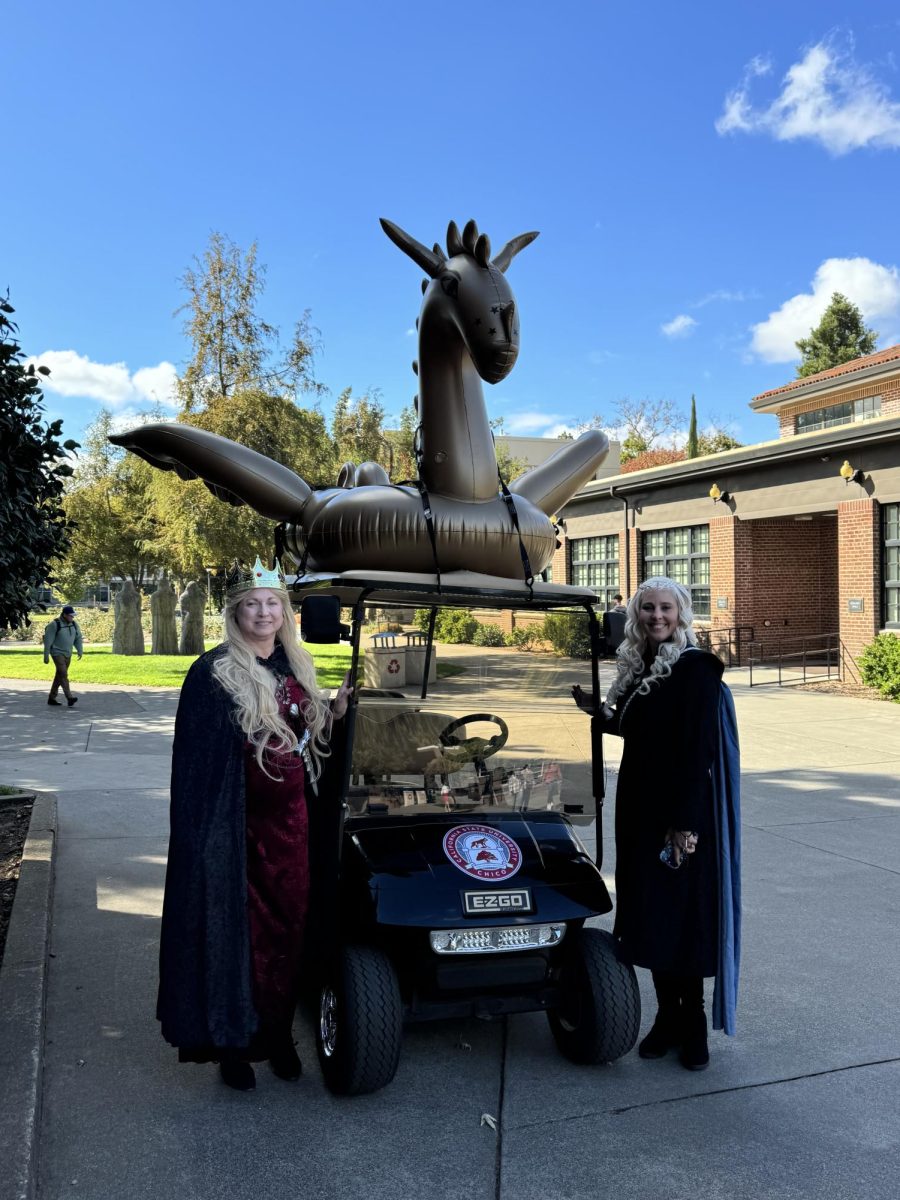 Cindy Scher-Hereth and Jamie Clyde pose next to a camps golf cart. Photo taken by Megan Gauer on Oct. 31. 