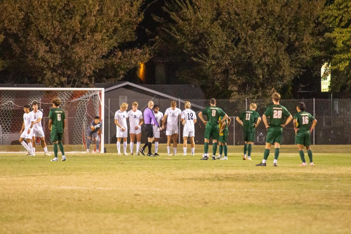 The ref makes sure the players are 10 yards away on Oct. 25 taken by Jenna McMahon. The goalkeeper ensures that the wildcats are lined up to block the free kick. 