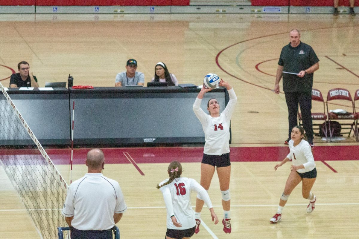 Claire Nordeen sets the ball for her teammate to spike over the net on Oct. 25 taken by Jenna McMahon. 