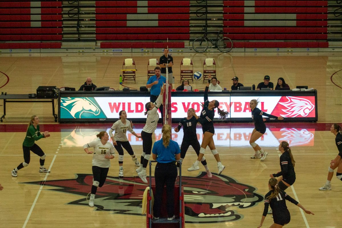 Number 12 Kailie Flores jumps to spike the ball over the net after her teammate number 18 Caitlyn Eichhorst set it for her on Oct. 26. Photo taken by Jenna McMahon. 