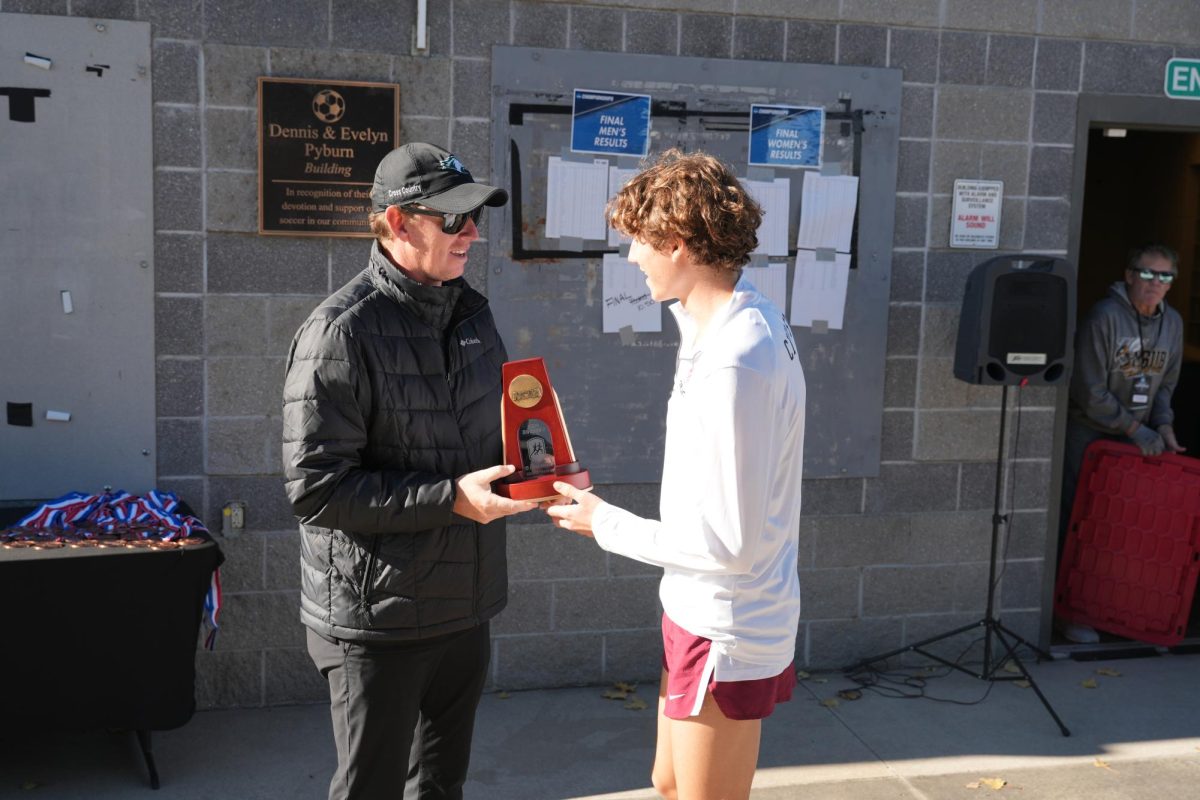 Sophomore Mario Giannini being awarded the west regional championship trophy after his first-place finish at the NCAA west regional on Nov. 9. Photo Courtesy of Montana State Billings