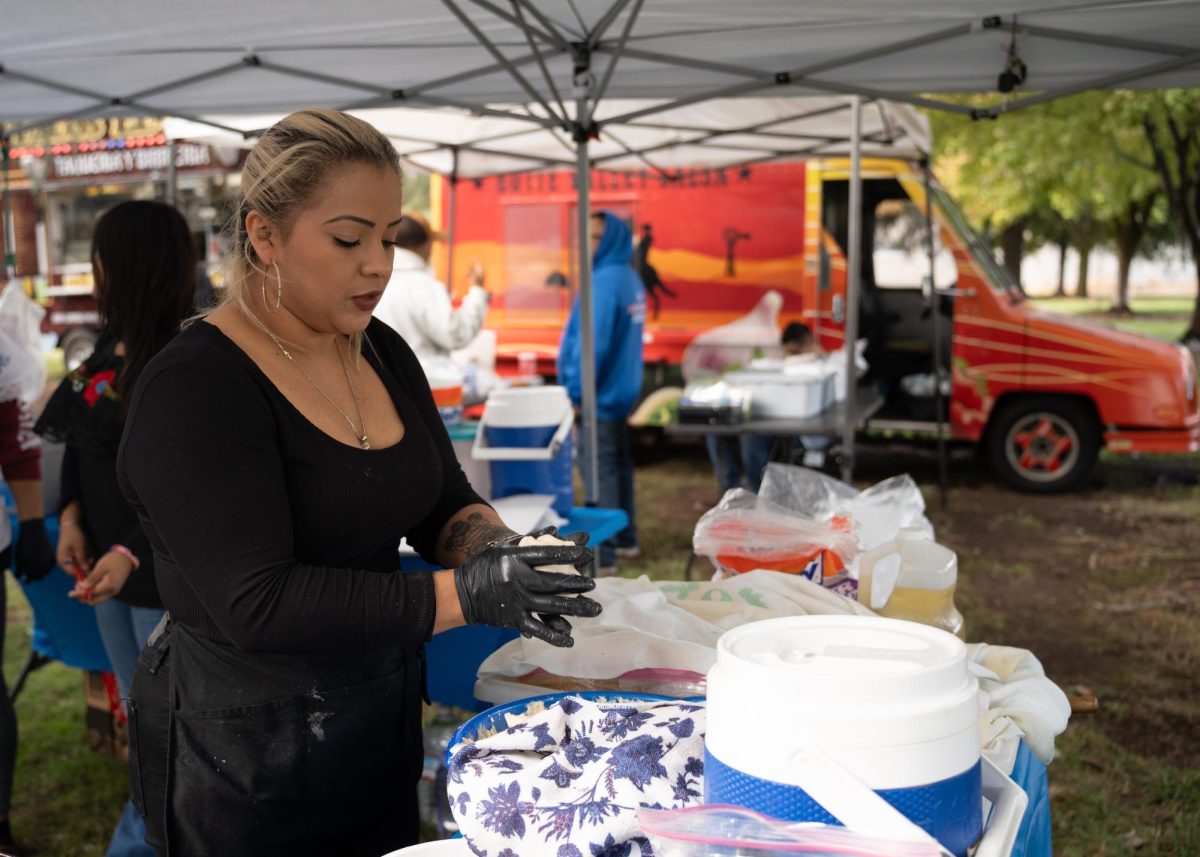 Yanette Hernandez and her siblings Karla and Gabriela Alvarez cook and sell traditional Salvadoran pupusas at the Dia de Muertos celebration. This was their second year attending and selling food at the event. Hernandez said being able to share her culture through food was important to her, as well as learning about other cultures at the event.
