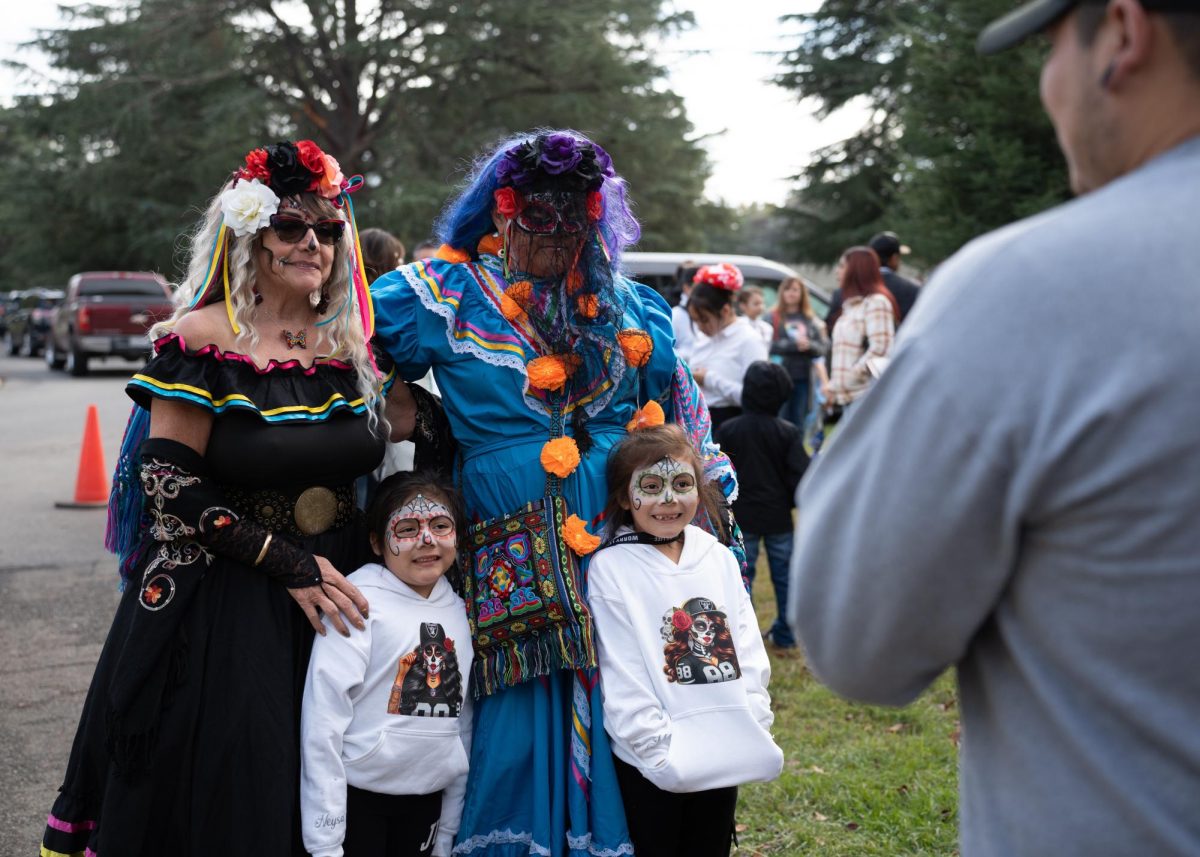 LeAnn Madina, left, and Maggie Ramirez, right, attend the Day of the Dead celebration at the Chico Cemetery with friends and family. Remembering ancestors and maintaining cultural traditions was the most important part about this day for them. However, they also embraced the sense of community and sharing of cultures on days like these.