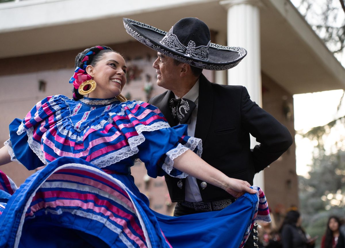 Instructor of Grupo de Danza Patria Insurgente Osvaldo Delgado, right,  and his wife Veronica Delgado, left, perform a traditional Folklorico dance from the region of Jalisco. Though Veronica learned more about Mexican culture after marrying her husband, she said passing that along to the kids was one of her passions. For Osvaldo, his performance and his team’s performance was a way of remembering and respecting those who passed.