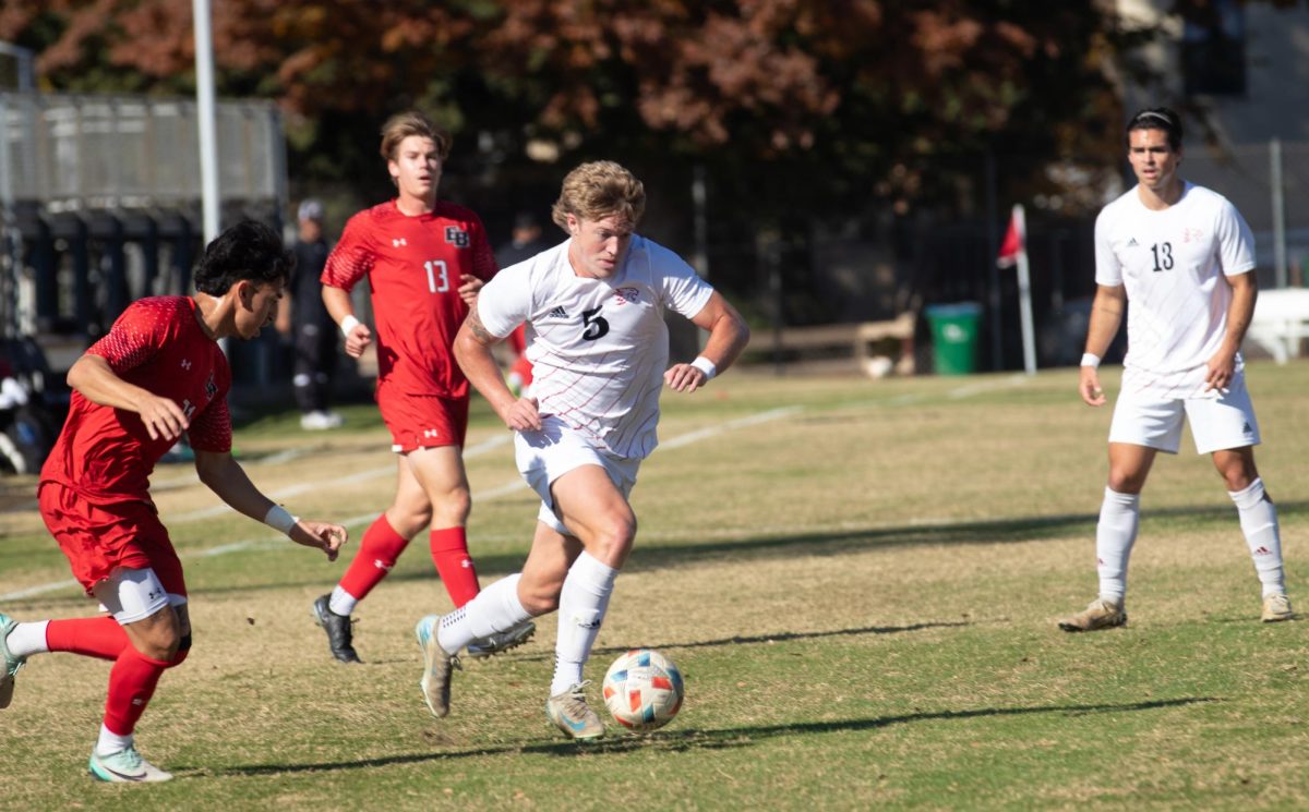 Senior forward Miles Rice works to keep the ball as East Bay’s defender James Garlick applies pressure during the first half of the game at Chico State Sunday, Nov. 10, 2024.