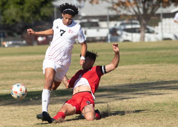 East Bay midfielder Drew Gibbons loses his  balance while attempting to intercept Sylas Sells’ control of the ball during the first half of the game at Chico State Sunday, Nov. 10, 2024.