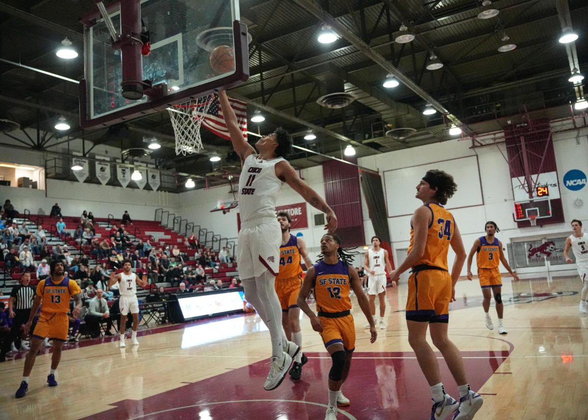 Sophomore Caden Harris drives through and jumps into the air for a layup during the first-half Saturday, Dec. 7, 2024, against San Francisco State at Chico State.