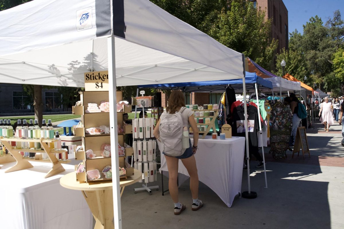 A student peruses the colorful selection of Ghost Poppy candles. Photo taken on Sept. 22.