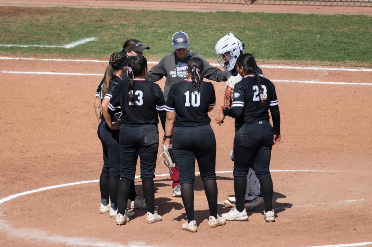 The Wildcats infield strategizing during a mid-inning timeout with Head Coach Angel Shamblin. Photo taken by Jason Halley on Mar. 29, 2025