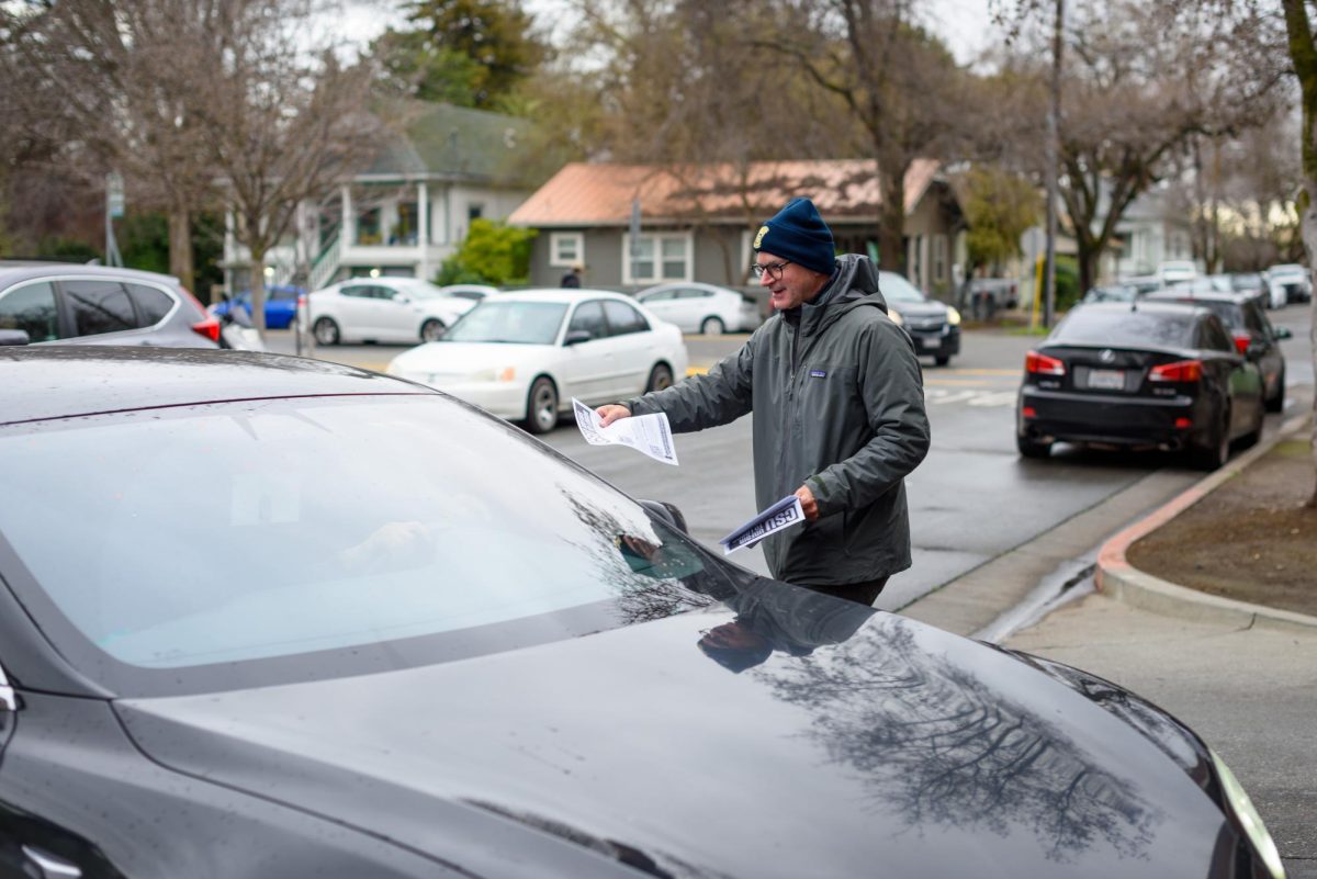 Steve Phillips, a member of the striking Teamsters Local 2010 union, hands out flyers to cars entering the Cherry St. parking structure while picketing on Tuesday, Feb. 17, 2026 in Chico, Calif. The teamsters say the CSU system is exploiting a loophole in their contract to deny previously-promised raises.
(Dash Ferrero/The Orion)