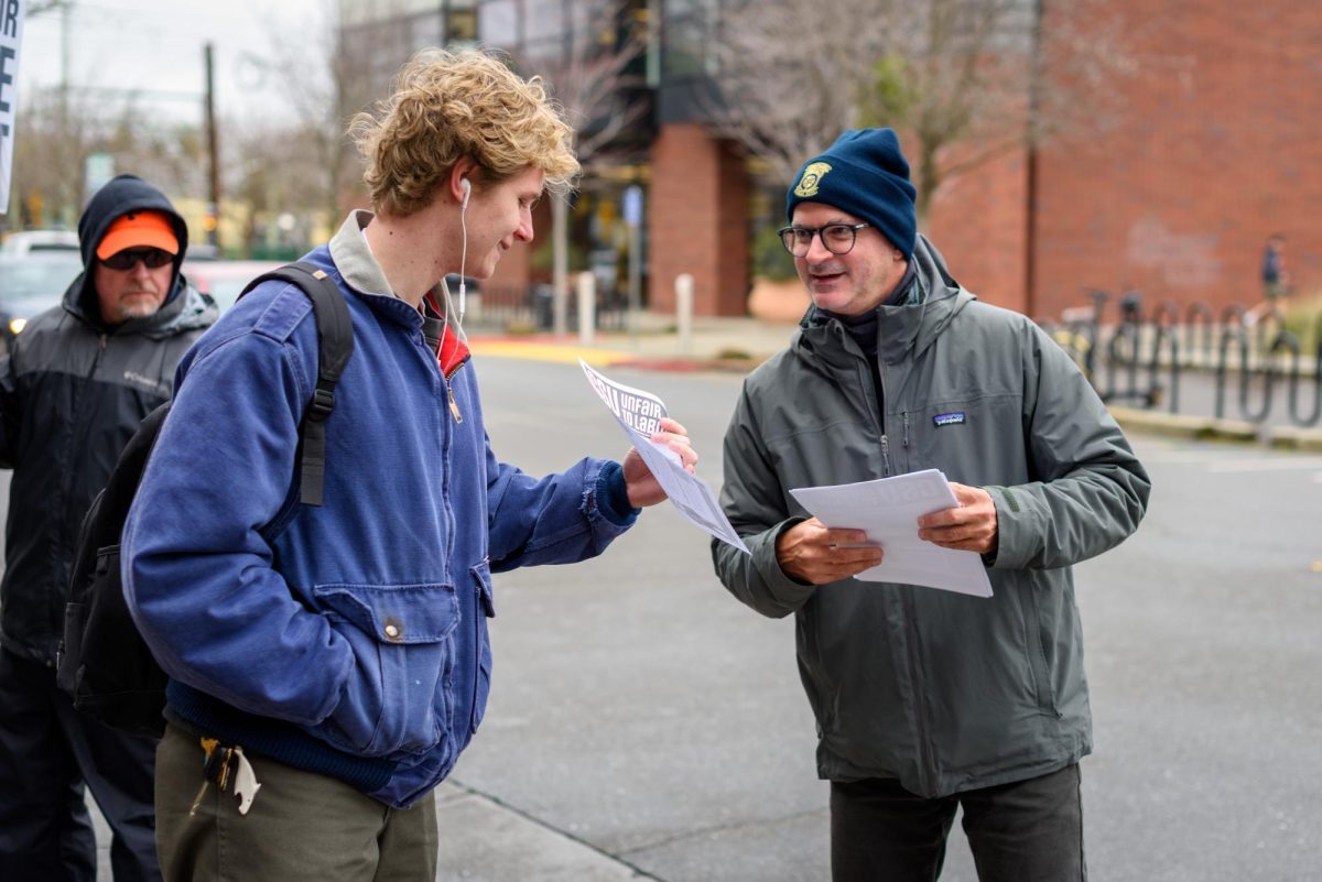 Steve Phillips (right), a member of the striking Teamsters Local 2010 union, hands out flyers to passing students in front of the Cherry St. parking structure while picketing on Tuesday, Feb. 17, 2026 in Chico, Calif. The teamsters say the CSU system is exploiting a loophole in their contract to deny previously-promised raises.
(Dash Ferrero/The Orion)