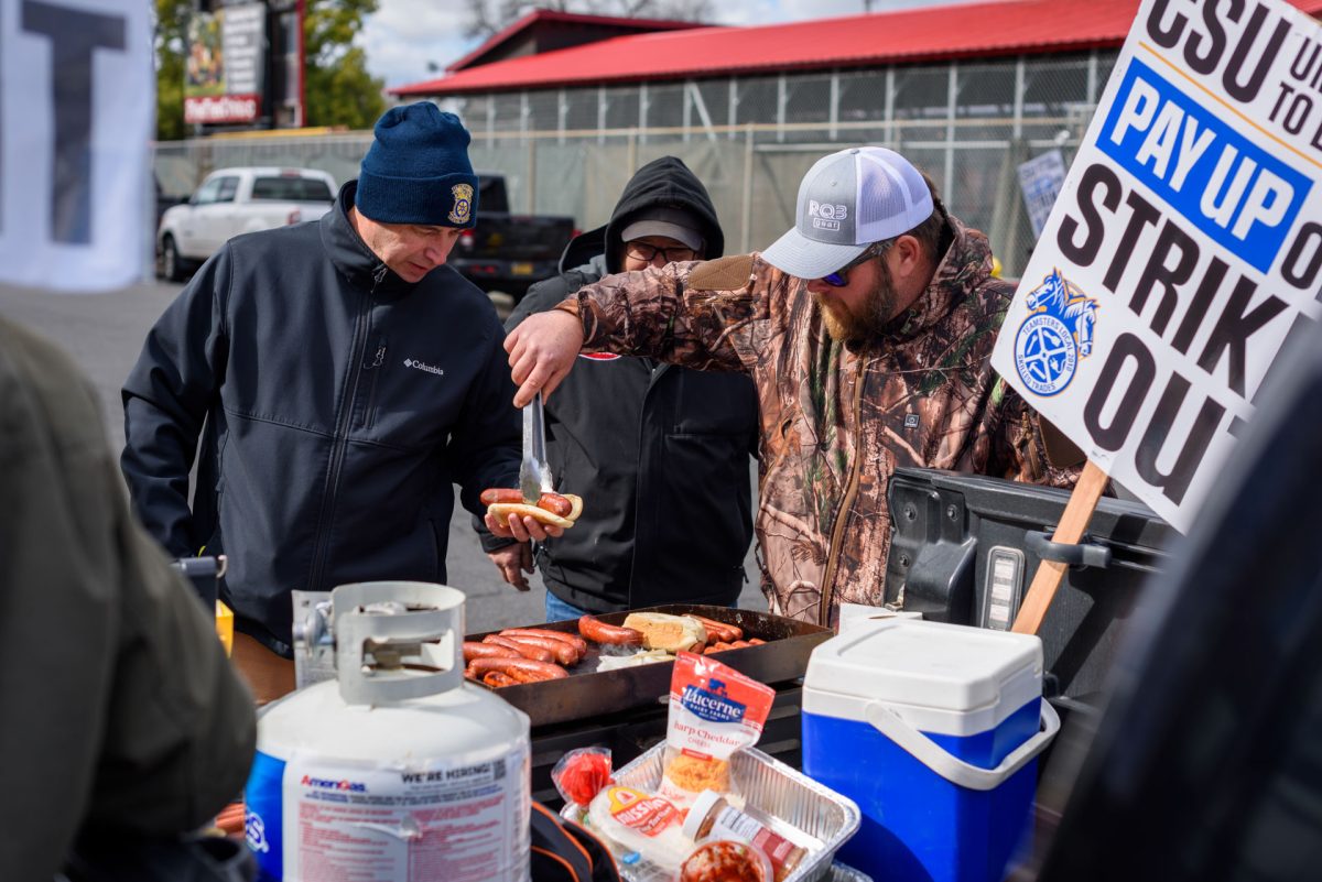 Members of the striking Teamsters Local 2010 union grill hot dogs for lunch while picketing along Legion Ave, behind Estom Jamani Hall on Wednesday. Photo taken by Dash Ferrero on Sept. 18, 2026.