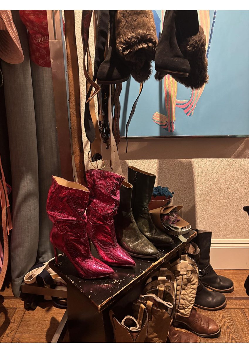 A selection of vintage boots and accessories curated by women-owned businesses sits on display during the Galentine’s Day pop-up at Enloe Mansion. Photo taken by Sydney Davis on Feb. 13, 2026