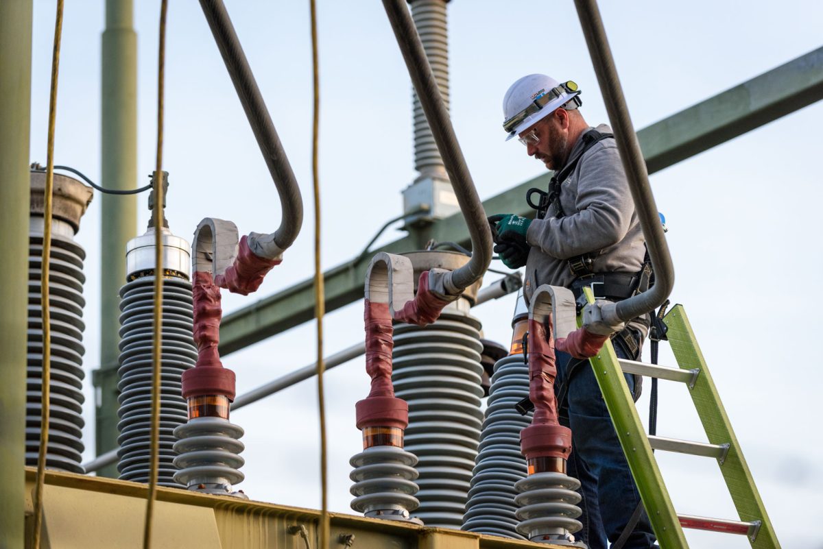 A PG&E worker takes photos of damage to a bushing on a transformer at the W 2nd & Orange St. substation following an outage that caused campus and much of the surrounding area to lose power on Monday, Mar. 9, 2026 in Chico, Calif.  PG&E workers who declined to give their names stated the damage was likely caused by a thrown object.
(Dash Ferrero/The Orion)