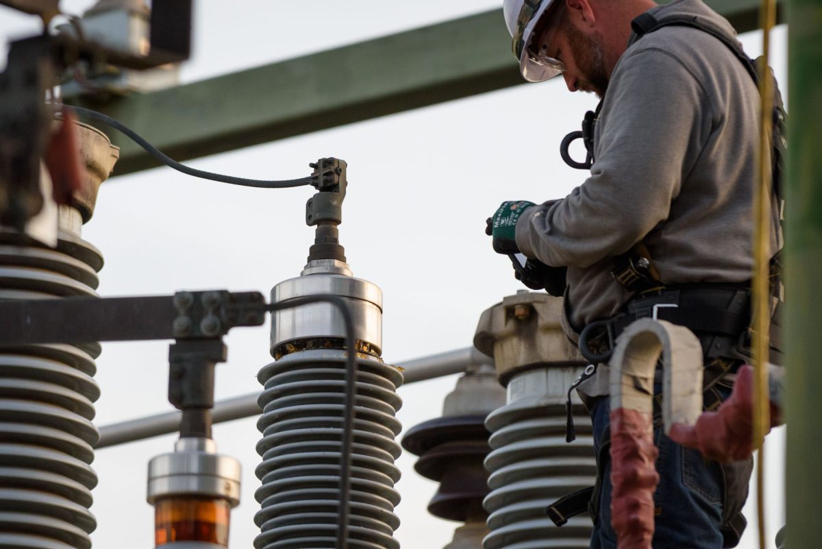 A PG&E worker takes photos of damage to a bushing on a transformer at the W 2nd & Orange St. substation following an outage that caused campus and much of the surrounding area to lose power on Monday, Mar. 9, 2026 in Chico, Calif.  PG&E workers who declined to give their names stated the damage was likely caused by a thrown object.
(Dash Ferrero/The Orion)
