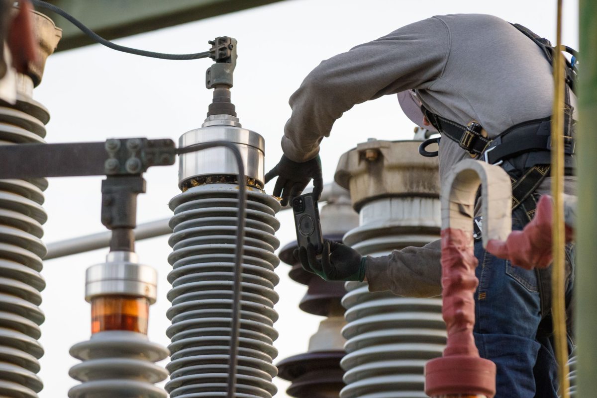 A PG&E worker takes photos of damage to a bushing on a transformer at the W 2nd & Orange St. substation following an outage that caused campus and much of the surrounding area to lose power on Monday, Mar. 9, 2026 in Chico, Calif.  PG&E workers who declined to give their names stated the damage was likely caused by a thrown object.
(Dash Ferrero/The Orion)