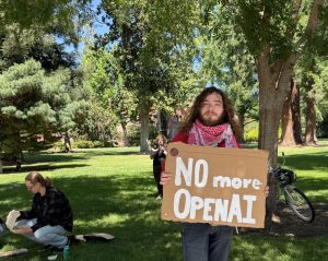 James Carlson joins the CSU-wide protest to divest from OpenAI while Kat Anderson speaks about the negative impacts of AI in the background.
Photo taken by Alexa Lima on April 23, 2026.