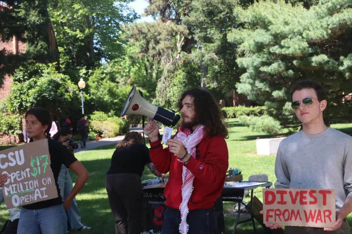 From left to right: Maya DeHoyos, Kat Anderson, James Carlson and . Students gathered across from Trinity Lawn to to protest against the contract between the California State University System and OpenAI for ChatGPT Edu. Photo taken by Chris Hutton on April 23, 2026.
