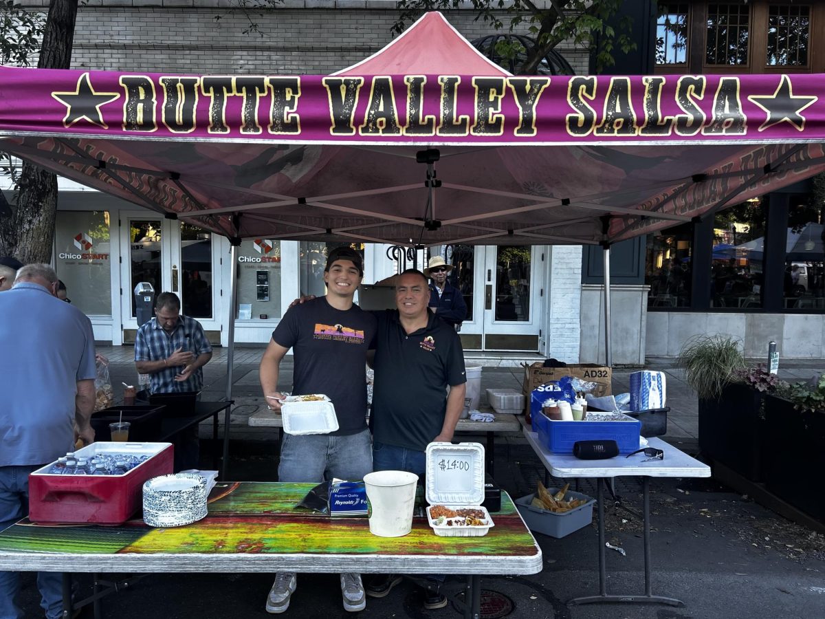 Antonio Flores (right) of Butte Valley salsa stand at Thursday night market. Photo taken by Bria Martinez April 23, 2026.